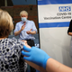 British prime minister Boris Johnson claps after a nurse administers the Pfizer/BioNTech Covid-19 vaccine.